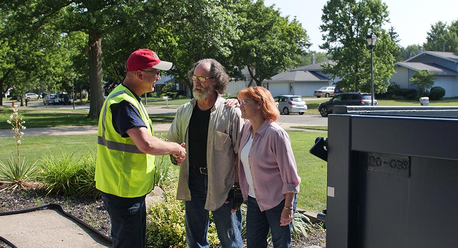 Two Homeowners Talking to a Budget Dumpster Truck Driver