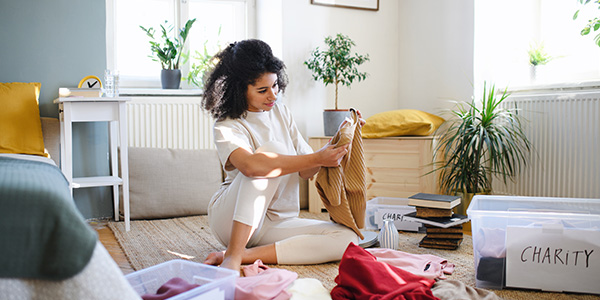 Woman Sorting Clothes Into Piles